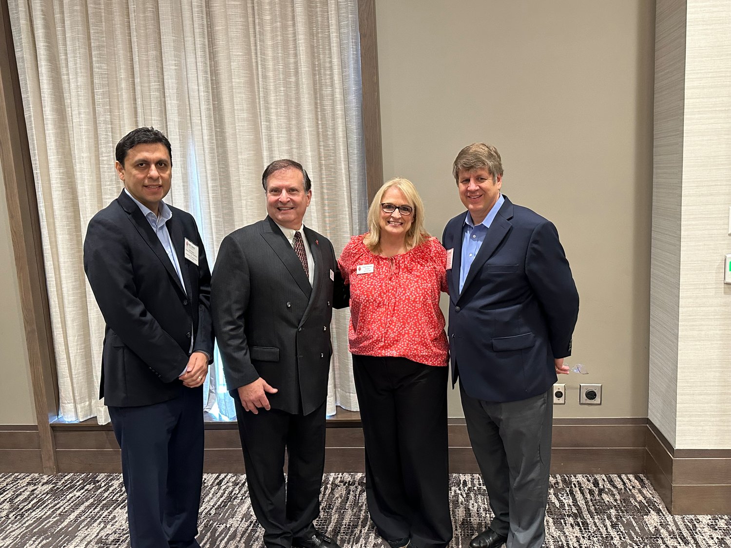 Carlos Guzman, Fort Bend County director of economic opportunity and development; Paul Kurt, Katy Area EDC chairman; Angie Thomason, Katy Area EDC president/CEO; and Patrick Jankowski, Greater Houston Partnership senior vice president of research, pose for a photo at the Katy Area EDC meeting.